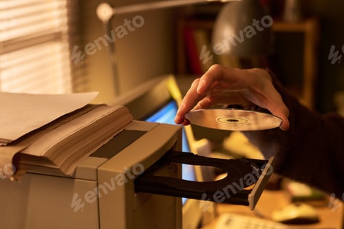 Preview: Caucasian Woman Inserting Compact Disc into Computer Drive