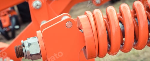 Preview: Hard red spring made of steel. Part and detail of industrial or agricultural machine