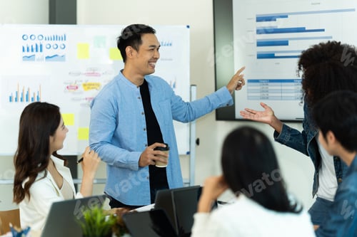 Preview: Business people showing team work while working in board room in office interior.