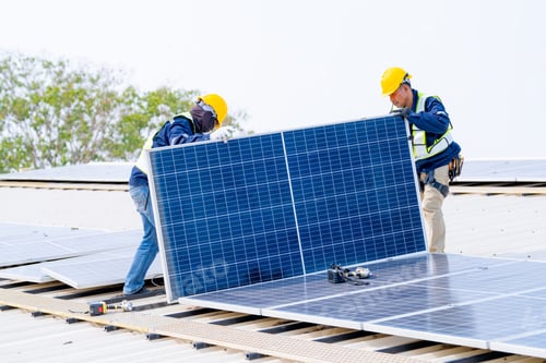 Preview: workers installing solar panels, for efficient energy on rooftop