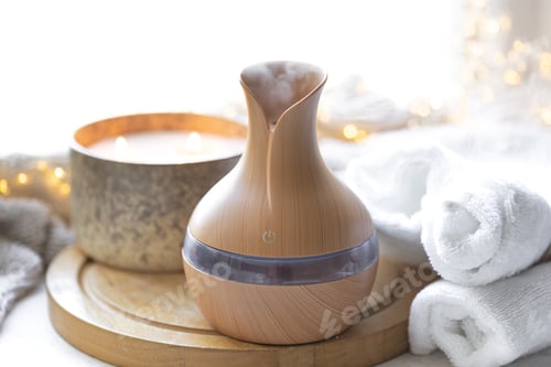 Preview: Cozy composition with essential oil aroma diffuser, towels and candles.