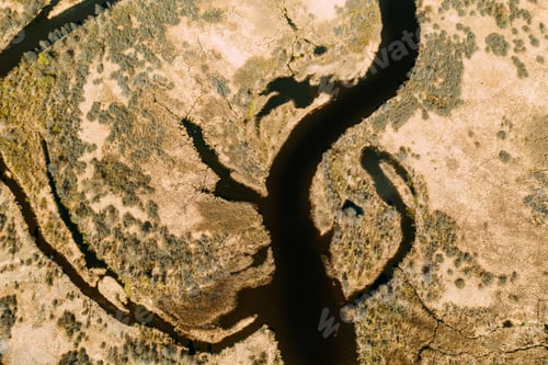 Preview: Aerial View Curved River In Early Spring Landscape. River bends and dry grass landscape. Top View Of