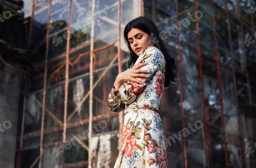 Preview: Stylish woman outside glass building