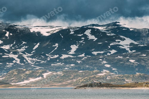 Preview: Oppland, Tyin Lake, Norway. Stones On Coast Of Beautiful Lake Tyin In Summer Cloudy Day. Norwegian