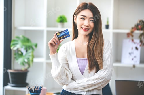 Preview: woman holding phone and credit card
