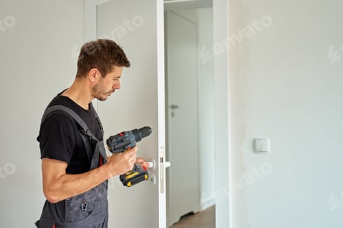 Preview: Man installing interior door with power drill