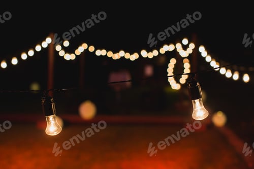Preview: outdoor string lights hanging on a line in backyard