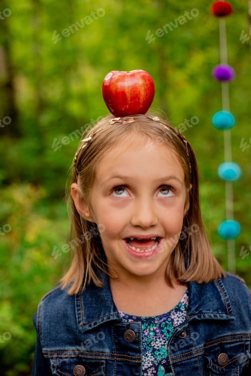 Preview: A girl with an apple on her head ready to go back to school