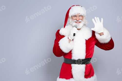 Preview: Santa Claus singing into microphone on color background. Christmas music