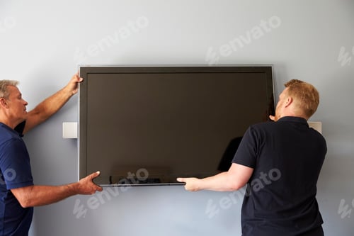 Preview: Two Men Fitting Flat Screen Television To Wall