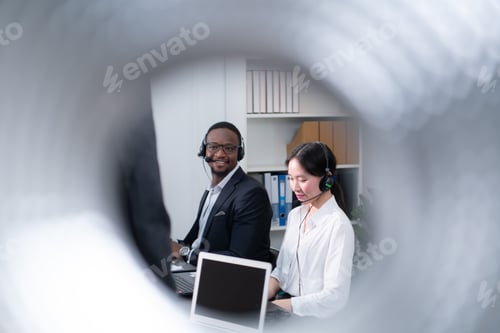 Preview: Portrait of business people wearing headset working actively in office.