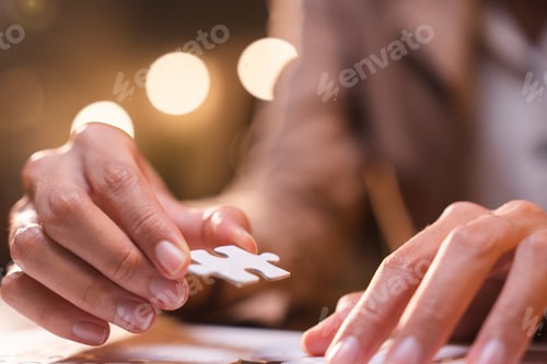 Preview: Business person team work holding jigsaw to connecting successful puzzle piece for matching