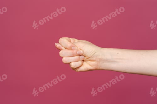 Preview: Women hand showing stop sign on a pink background