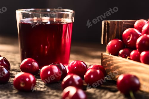 Preview: Fresh cherries in a wooden box and cherry juice