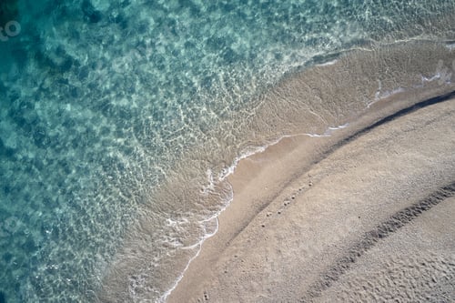 Preview: Top view of beach and coastline with clear water.