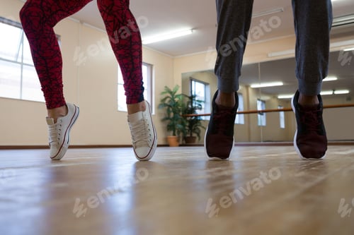 Preview: Low section of woman with friend practicing dance