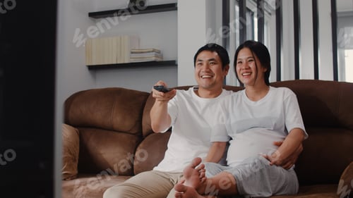 Loving Couple Relaxing at Home Together on Sofa