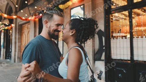 Preview: Happy interracial couple dancing outdoors