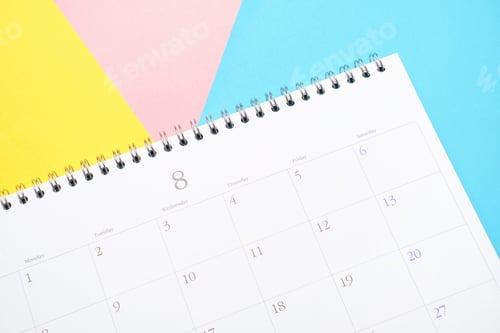 Preview: White calendar on colorful background close up, planning concept.