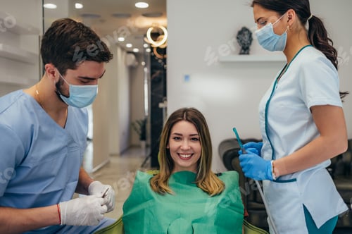 Preview: Woman patient in dental clinic being examined by a male dentist