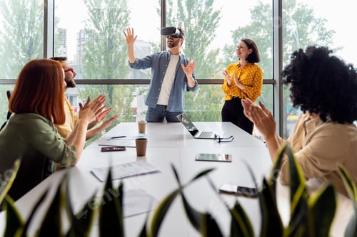 Preview: Young man wearing VR goggles, playing virtual reality online games during team building training