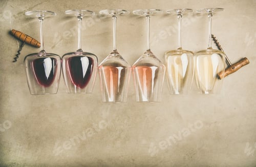 Preview: Different wines in glasses in row and corkscrews, top view
