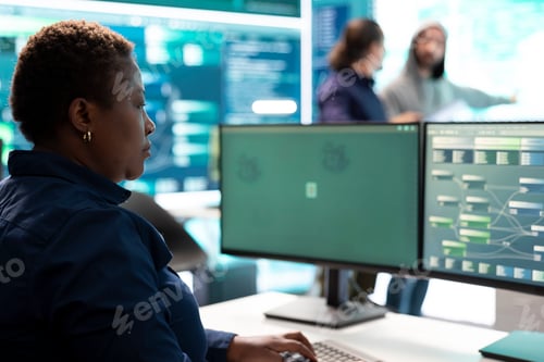 Preview: Woman governmental hacker analyzing digital threats on a computer