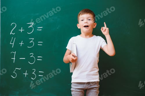 Preview: Back to school concept. School child in class. Happy kid against green blackboard