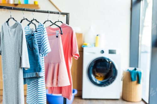 Preview: clothes on hangers and washing machine at home
