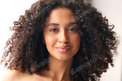 Preview: Close Up Studio Portrait Of Smiling Natural Woman Standing Against Neutral Background