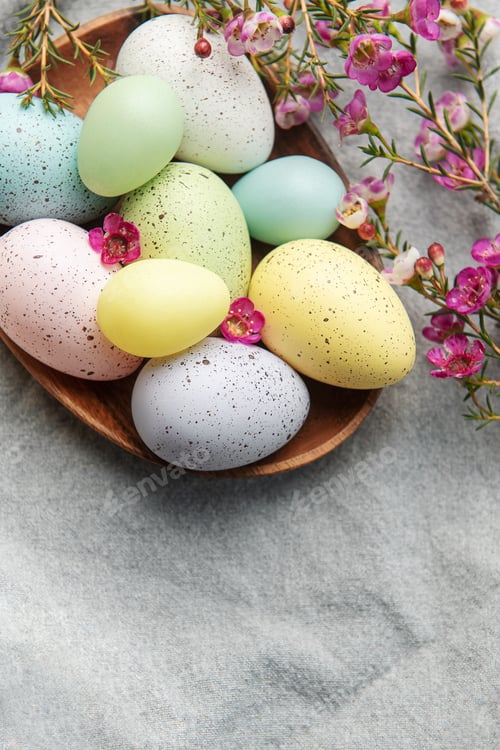 Preview: Easter decor. Colored Easter eggs on a wooden plate on the table.