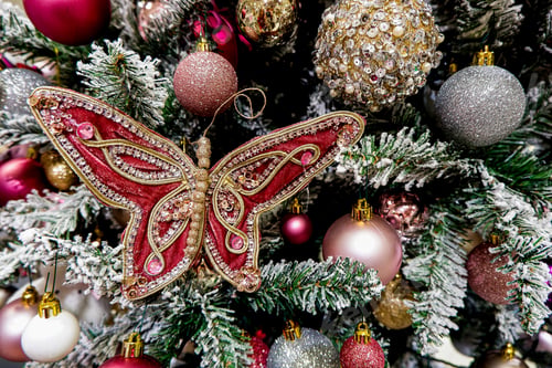 Preview: Vintage Christmas tree decorated with various ornaments. toys and baubles. Festive background