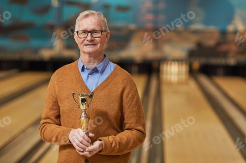 Preview: Senior Bowling Player Holding Trophy