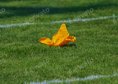 Preview: Minimalist image of penalty flag on a football Field.