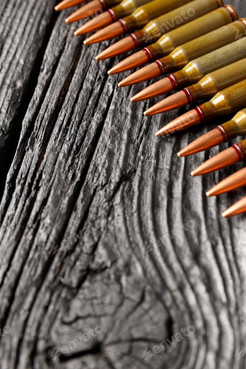 Preview: Bullets, ammunition on a black wooden background, close-up