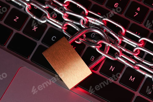 Preview: Cyber safety. Metal padlock with chain on laptop in color light, top view