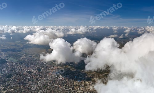 Preview: Aerial view from airplane window at high altitude of distant city