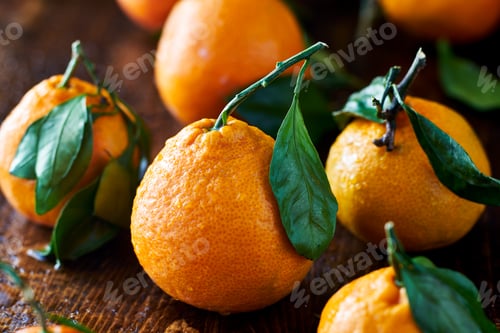 Preview: pile of fresh oranges with leaves still on stem