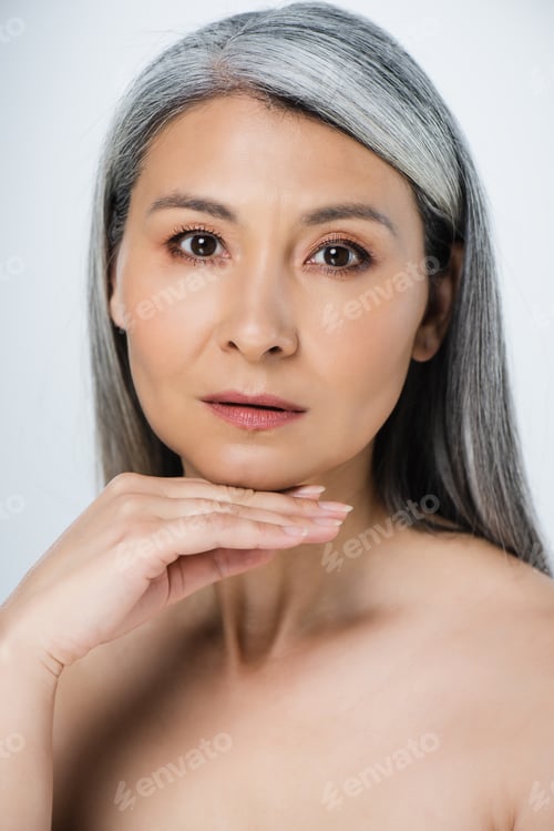 Preview: adult asian naked woman with perfect skin and grey hair isolated on grey