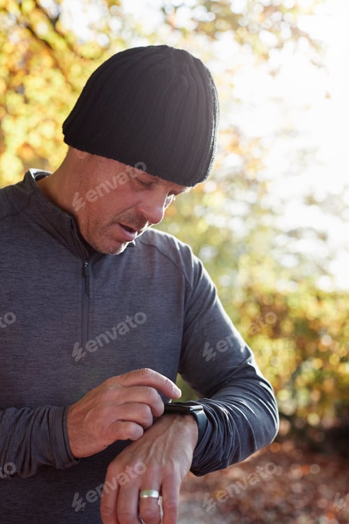 Preview: Mature Man On Autumn Run Checking Activity Tracker