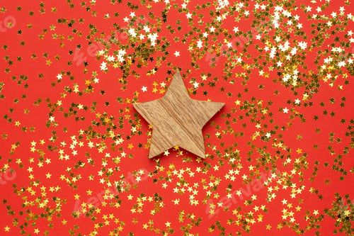 Preview: Wooden decoration star with golden stars confetti on red color background
