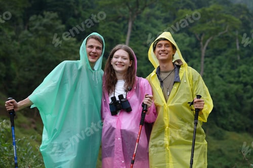 Preview: Hikers walking along a trail on a mountain with hiking sticks