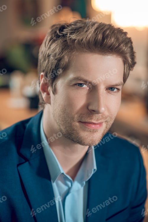 Preview: Young adult man in blue jacket