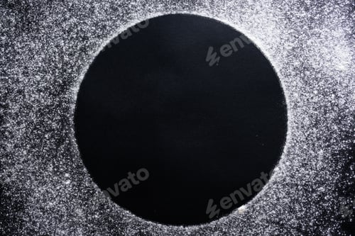 Preview: Abstract background. Sprinkled wheat flour circle, round spot on black.