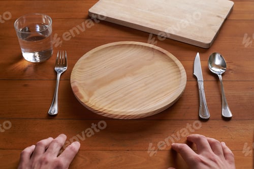 Preview: Point of view of a person about to eat on an empty wooden plate