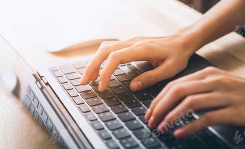 Preview: Hand using laptop and hand typing on the computer keyboard in the office.