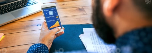 Preview: Businessman looking mobile with bitcoins information