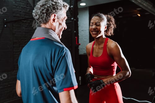 Preview: Fit senior man in the gym with his personal trainer.