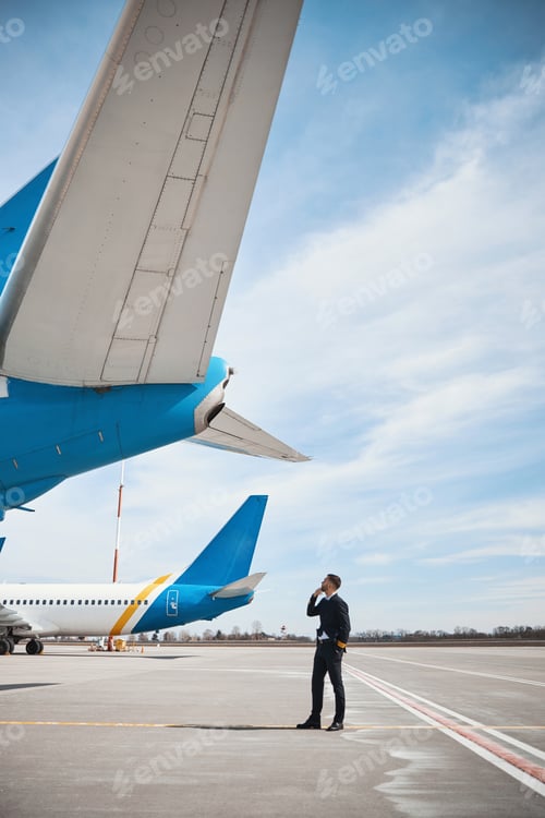 Preview: Plane captain studying aircraft rudder from behind