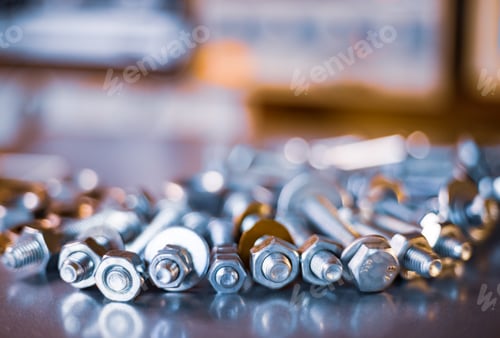 Preview: Metal chrome bolts and nuts in a chaotic order industrial background